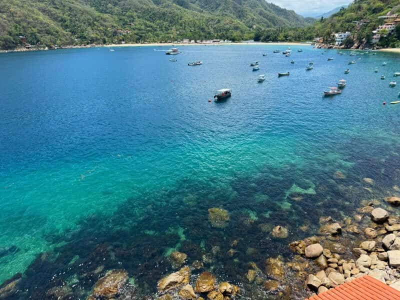 Clear water and rocks below the house